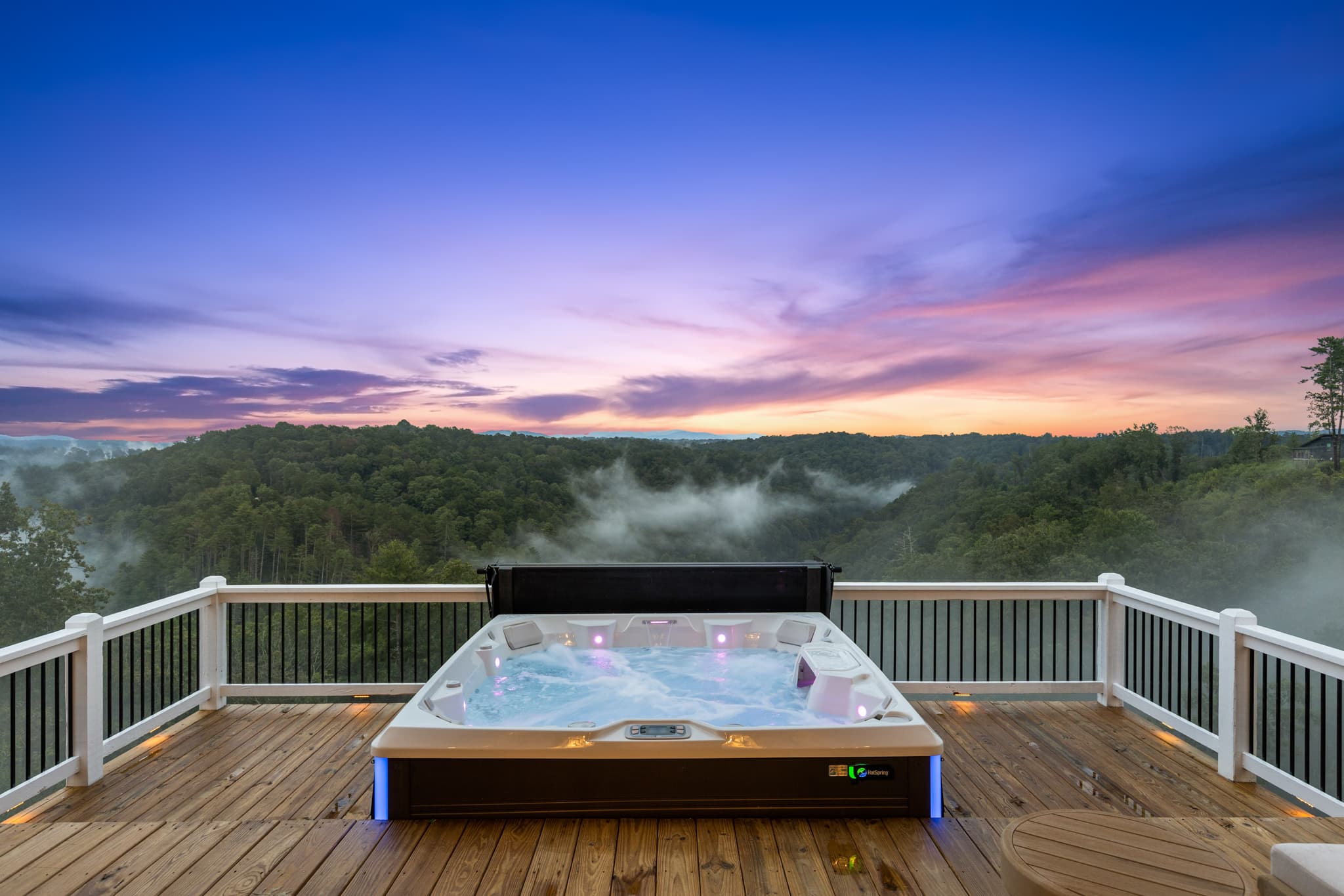 Private hot tub at sunset with mountain views