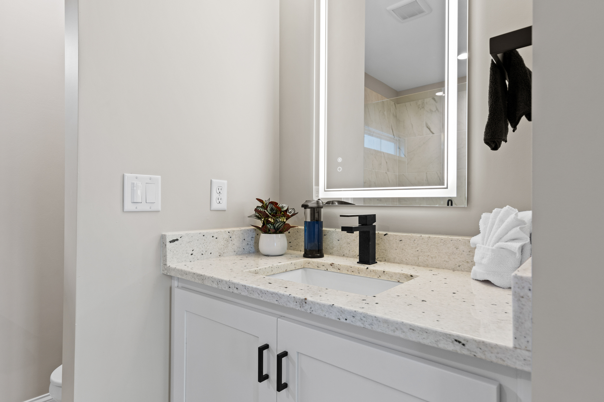 Bathroom vanity with LED mirror and granite