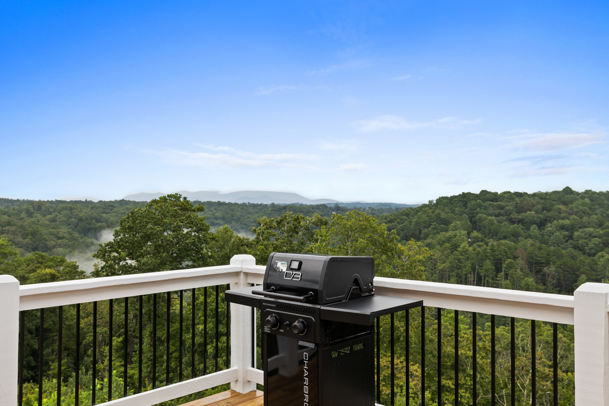Deck with BBQ grill overlooking mountains