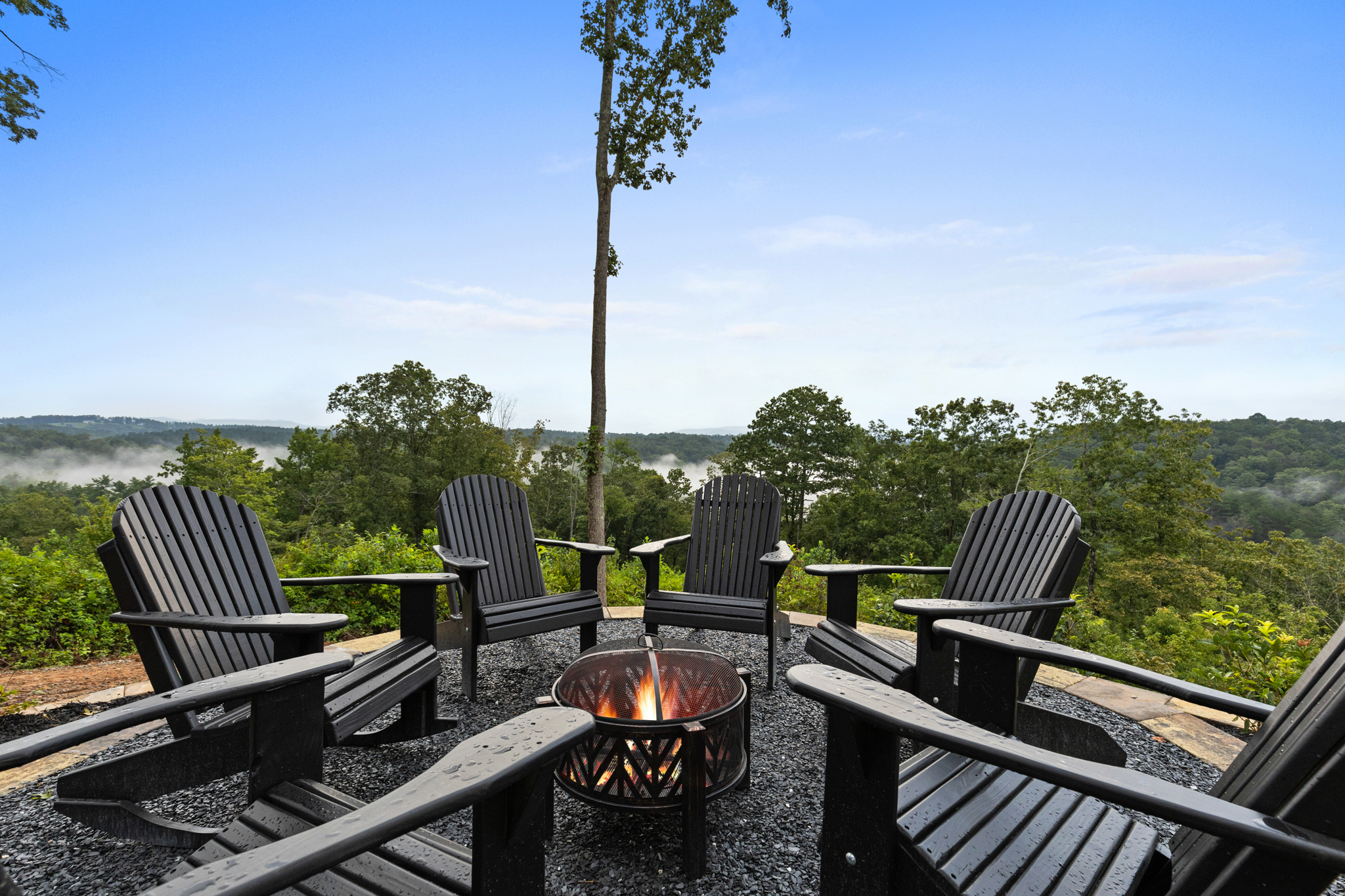Fire pit with Adirondack chairs and mountain view