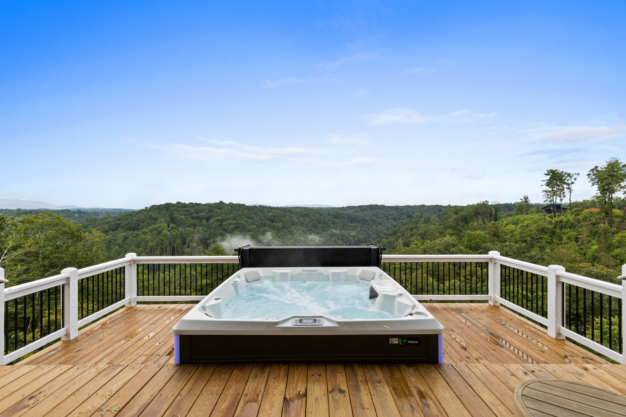 Hot tub with mountain backdrop during day