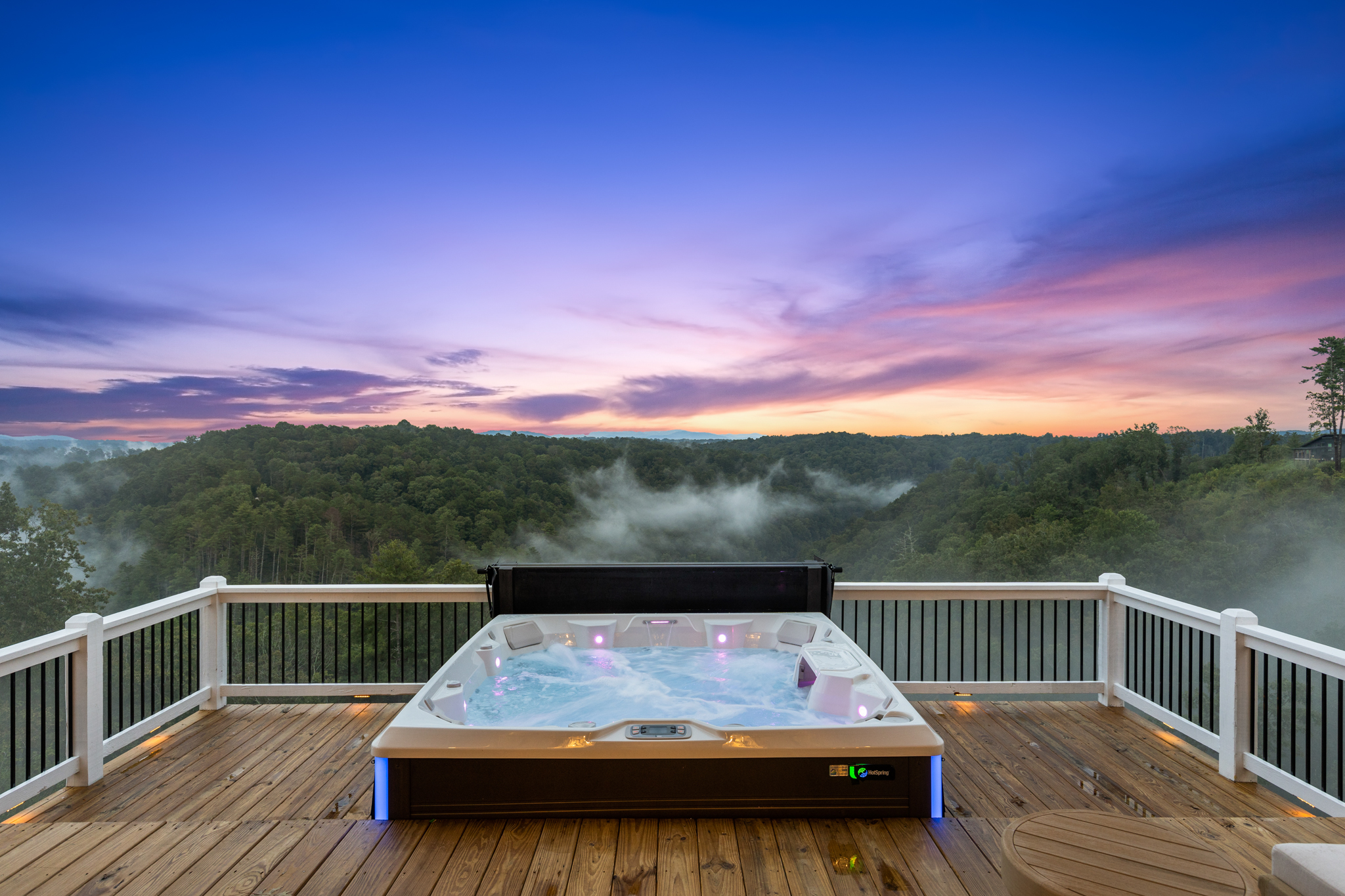 Hot tub with LED lights and purple sunset sky