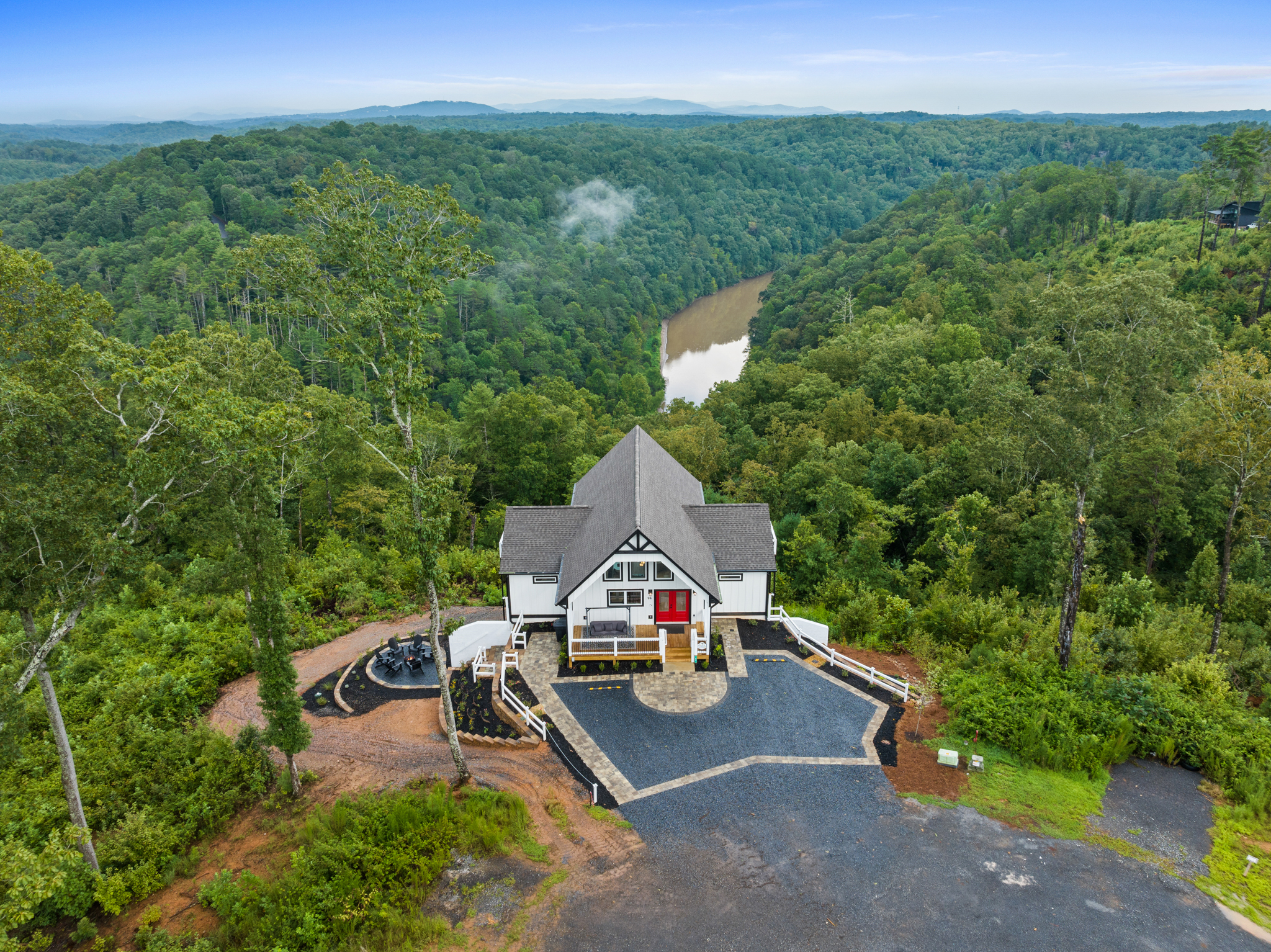 Aerial showing cabin with river valley below