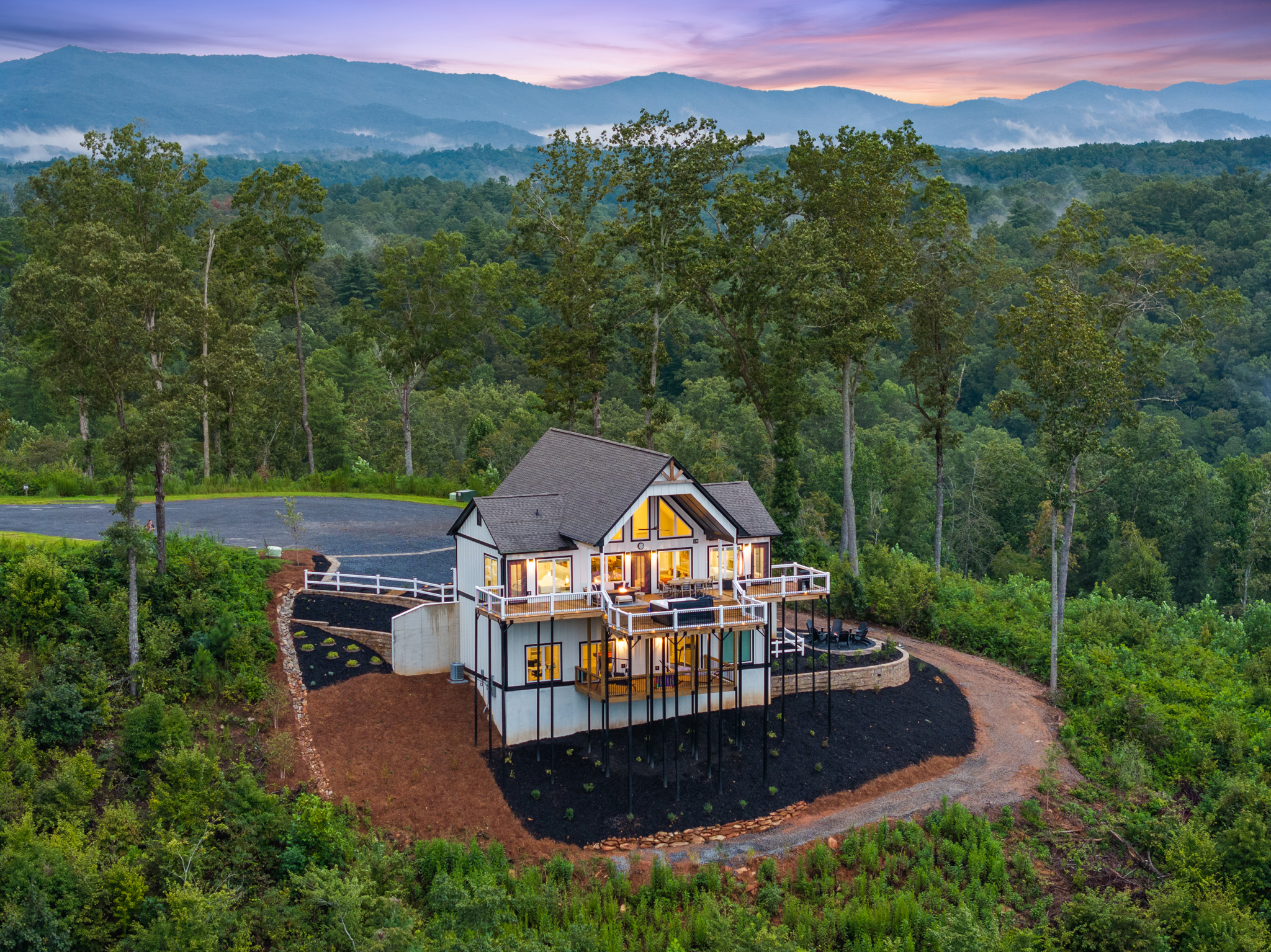 Wide aerial with dramatic sunset sky over mountains