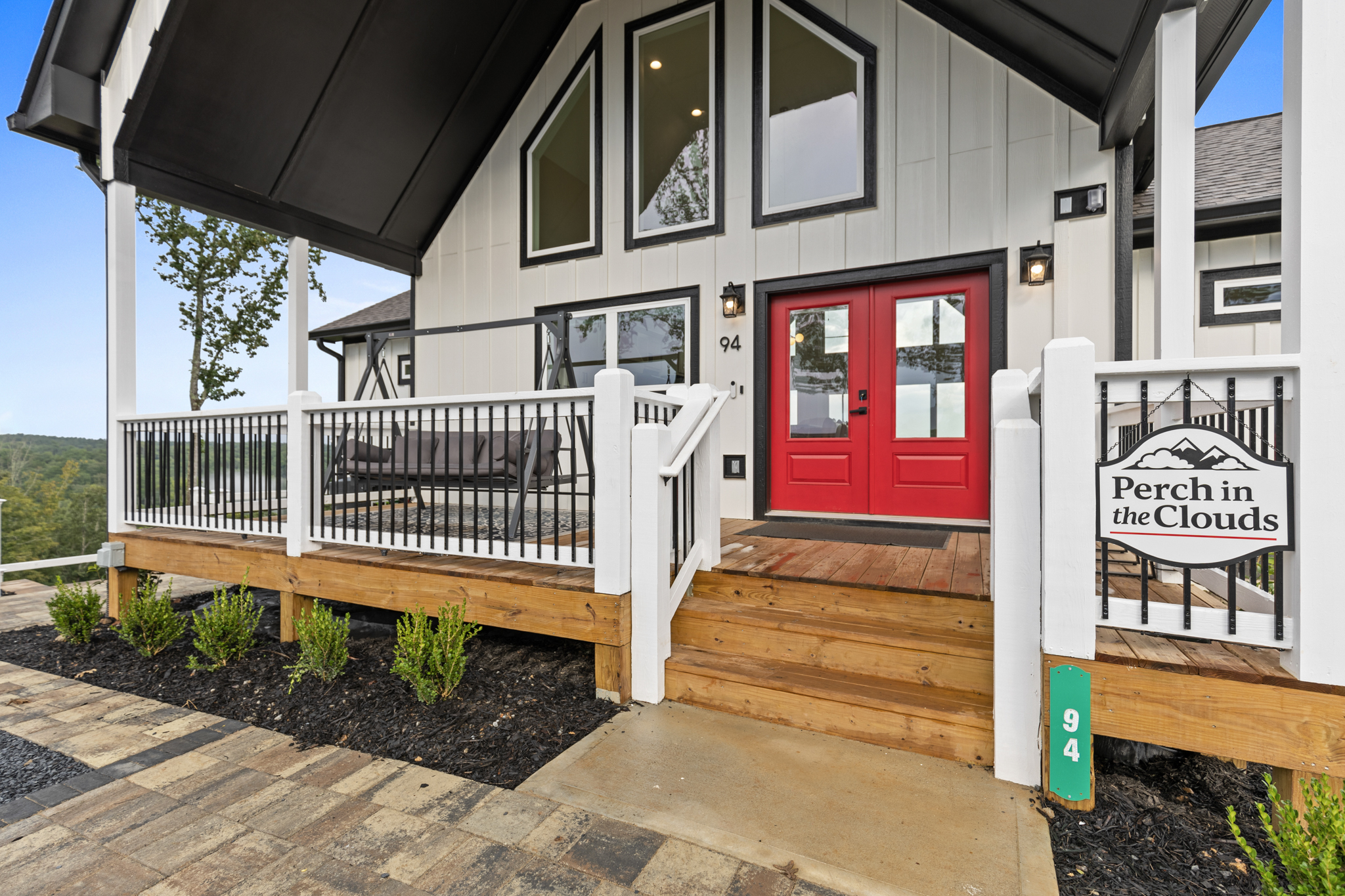 Front porch with Perch in the Clouds welcome sign