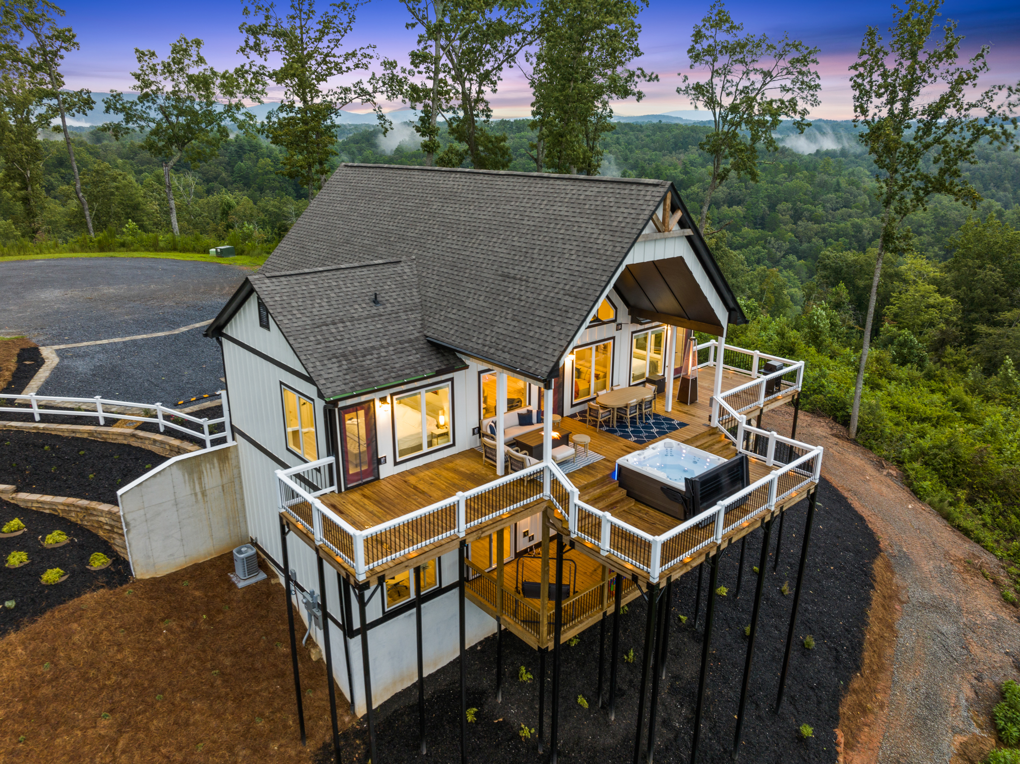 Side aerial at twilight with misty mountain view