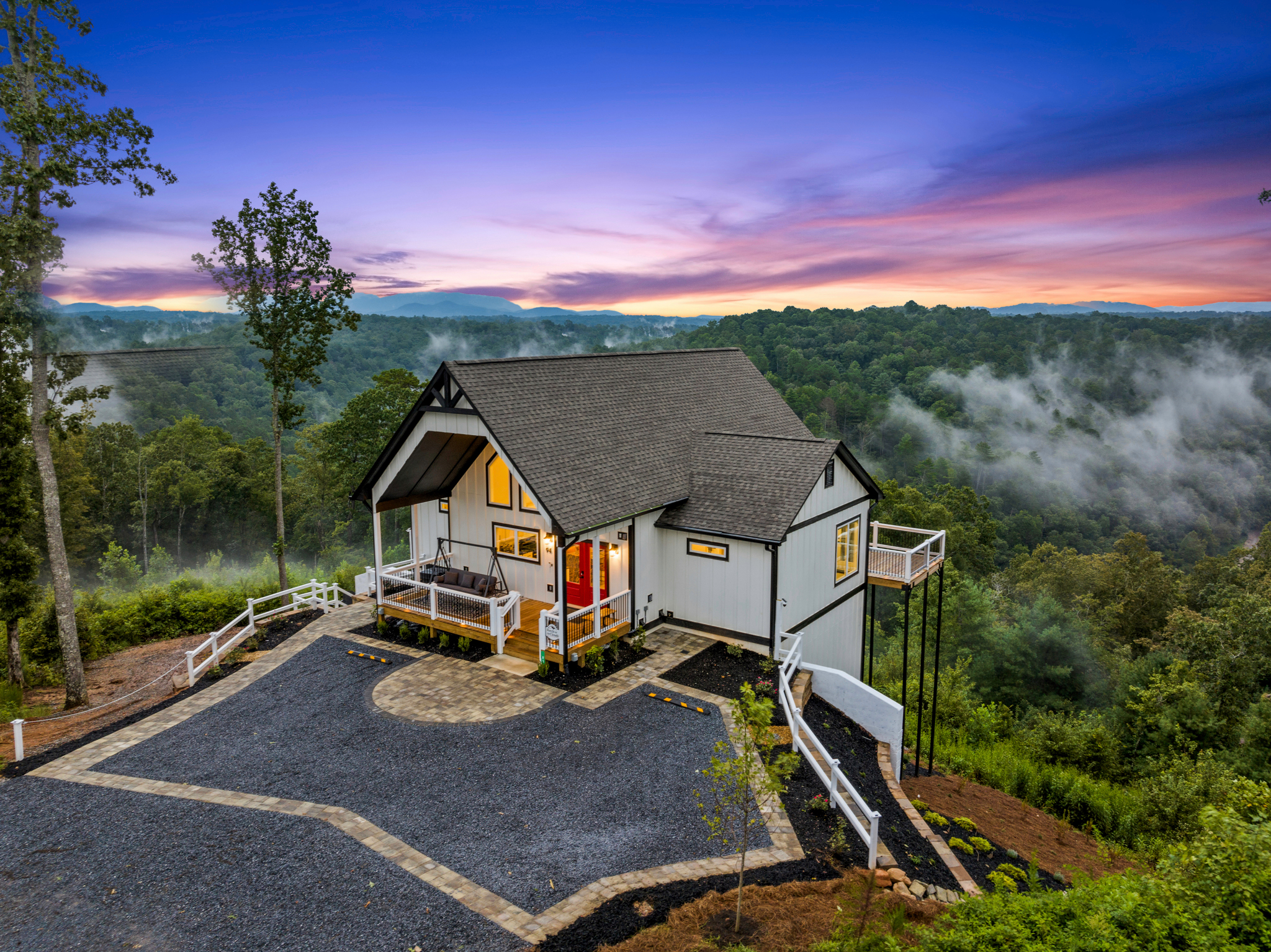 Cabin front at evening with warm interior lighting