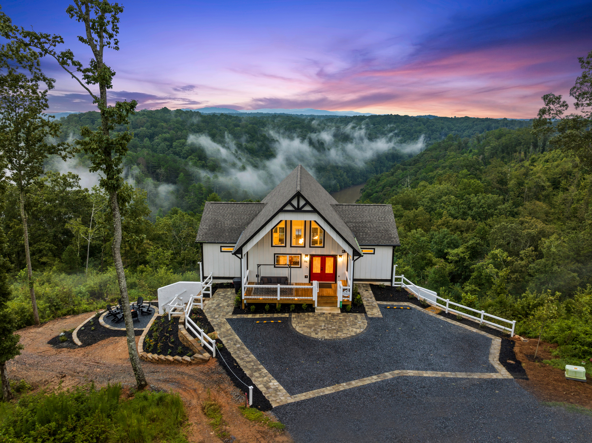 Dramatic twilight shot with purple sky and glowing windows
