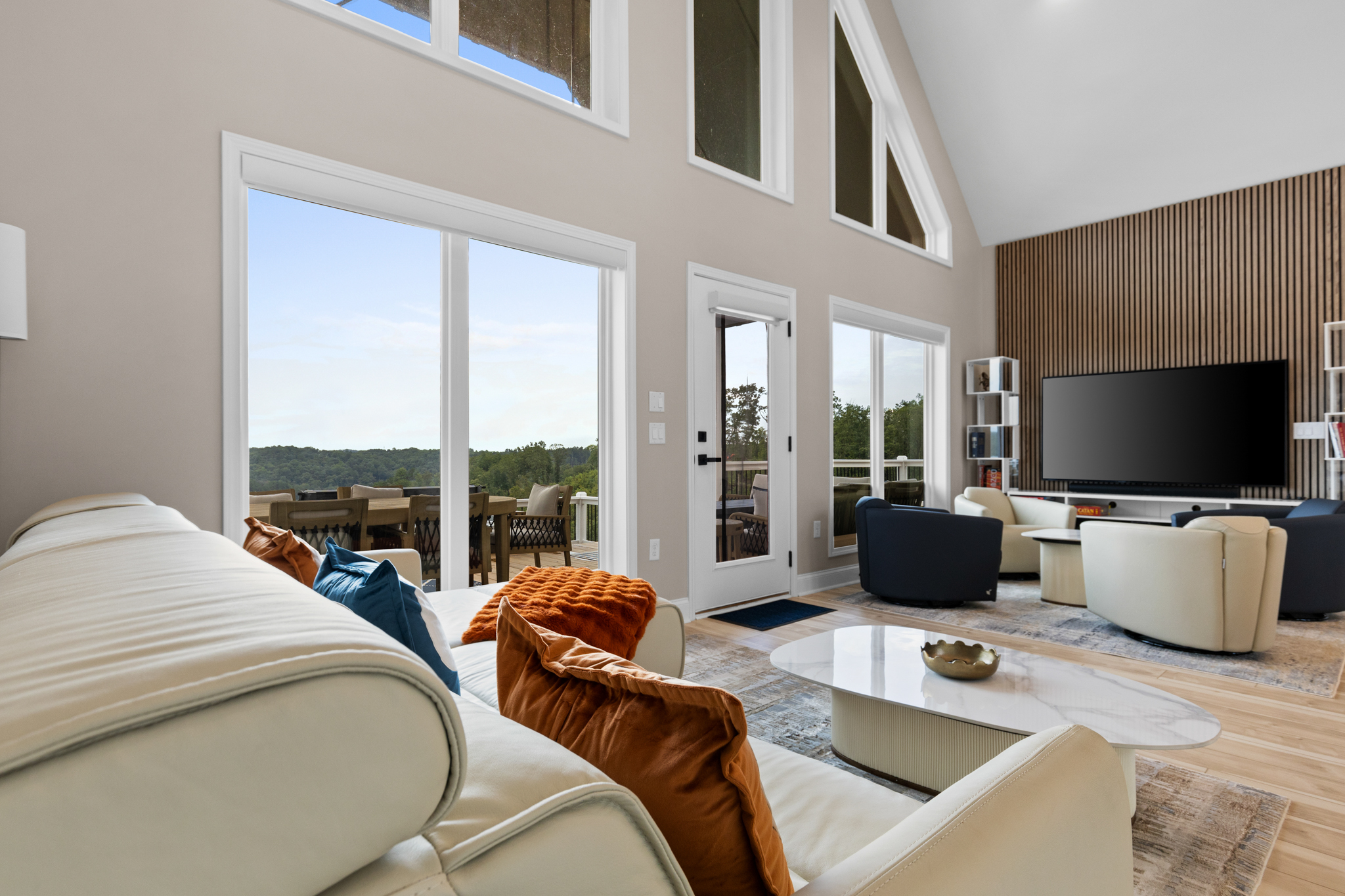 Living room sofa area with deck and mountain views