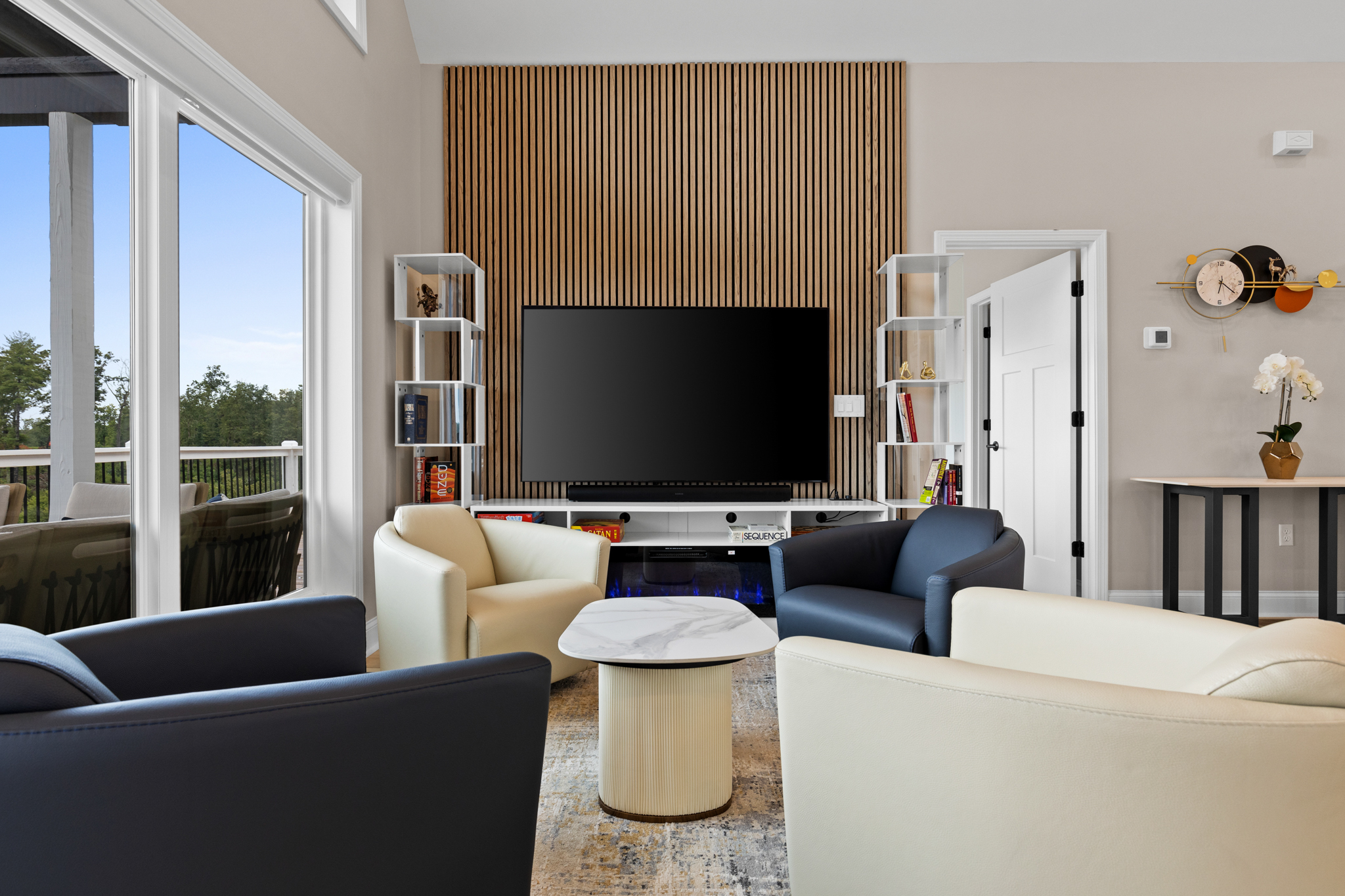 Living room showing fireplace, swivel chairs, and board games