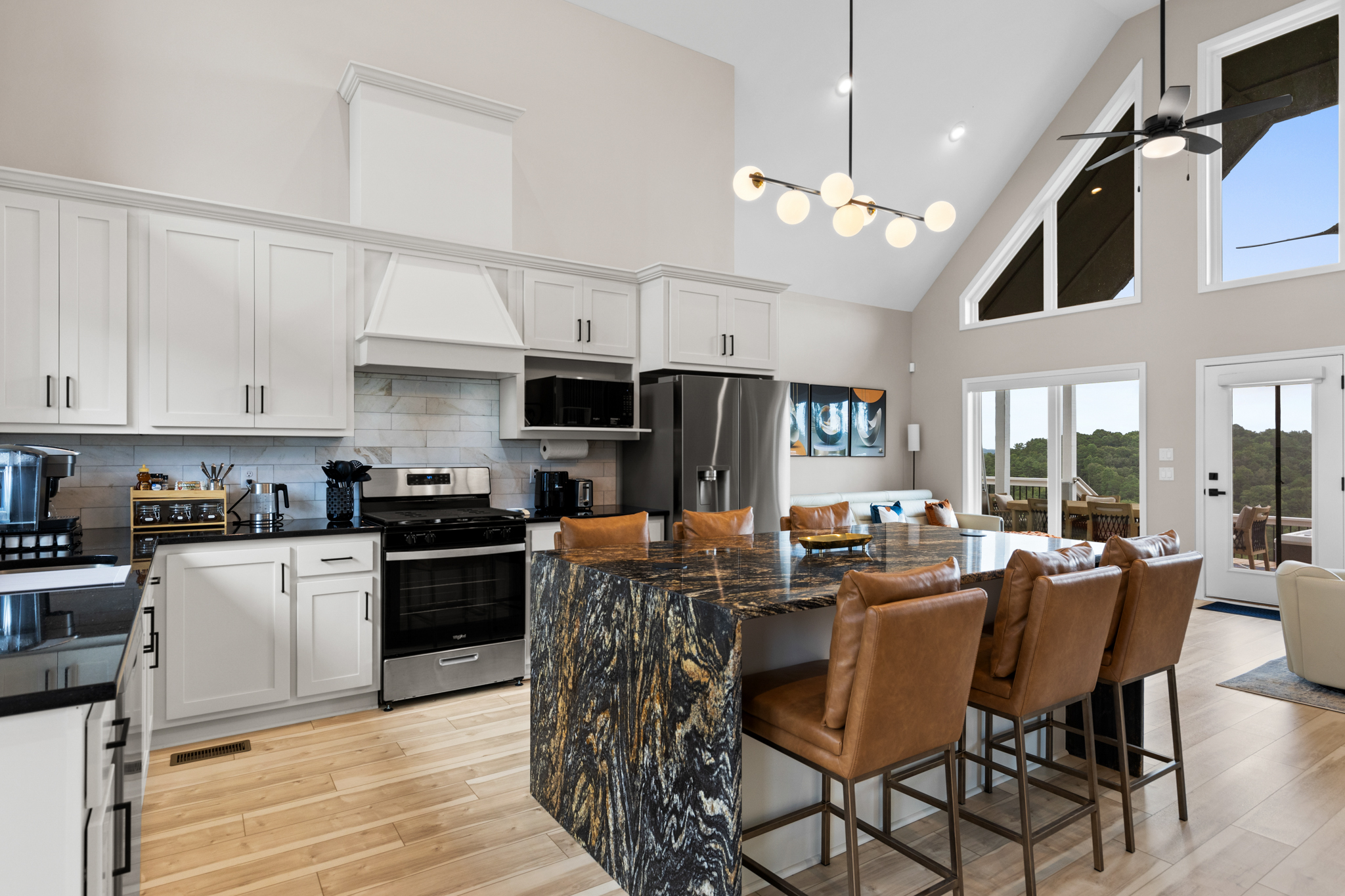 Living area with floor-to-ceiling windows and deck views