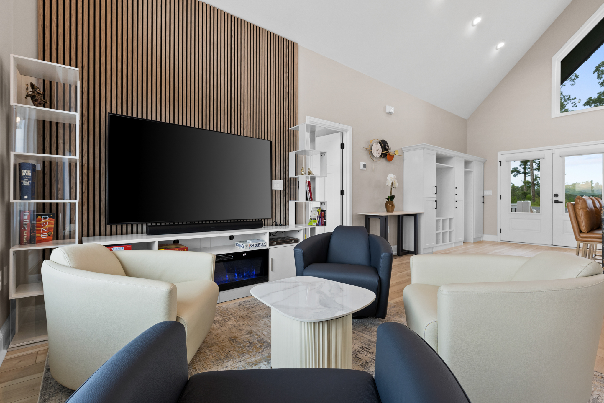 TV wall with wood slat accent and swivel chairs